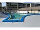 Inviting community pool featuring a light blue interior, white surrounding fence, and lounge seating at 3821 Lake Bayshore Dr # H-507, Bradenton, FL 34205