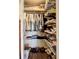 Walk-in closet with tons of clothes neatly arranged on shelves and racks at 3821 Lake Bayshore Dr # H-507, Bradenton, FL 34205