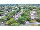 Captivating aerial perspective reveals community homes harmoniously blending with trees and tranquil lake vistas at 3842 Glen Oaks Manor Dr, Sarasota, FL 34232