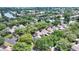 Scenic aerial view showcases the community's homes nestled among lush trees, and overlooking serene lakes at 3842 Glen Oaks Manor Dr, Sarasota, FL 34232