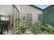 Lush courtyard view with stone flooring, potted plants, and natural light streaming in at 3842 Glen Oaks Manor Dr, Sarasota, FL 34232