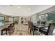 Bright, open floor plan with a dining area featuring modern chairs and views to the backyard at 3842 Glen Oaks Manor Dr, Sarasota, FL 34232