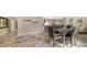 Elegant dining room with marble floors, a modern table set, and decorative wall art at 3842 Glen Oaks Manor Dr, Sarasota, FL 34232