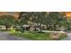 Beautiful home showcasing mature trees, lush landscaping, and inviting curb appeal at 3842 Glen Oaks Manor Dr, Sarasota, FL 34232