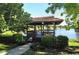 Charming gazebo nestled along the lake, providing a peaceful retreat in a serene setting at 3842 Glen Oaks Manor Dr, Sarasota, FL 34232