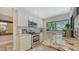Bright kitchen with granite countertops, stainless steel appliances, and view to the backyard at 3842 Glen Oaks Manor Dr, Sarasota, FL 34232