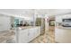 Spacious kitchen with white cabinetry, stainless steel appliances, and bar seating at 3842 Glen Oaks Manor Dr, Sarasota, FL 34232