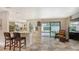 Bright kitchen with bar seating, a view of the pool, and modern appliances at 3842 Glen Oaks Manor Dr, Sarasota, FL 34232