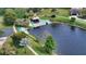 Picturesque lake view featuring a charming gazebo, boat ramp, and manicured walking path at 3842 Glen Oaks Manor Dr, Sarasota, FL 34232