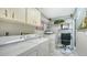 This laundry room includes a laundry machine, dryer, and office space at 3842 Glen Oaks Manor Dr, Sarasota, FL 34232