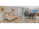 Comfortable living area with a lounge chair and dining table set, filled with natural light at 3842 Glen Oaks Manor Dr, Sarasota, FL 34232