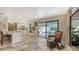 Open living space with a view to the pool area, featuring bar seating and stylish decor at 3842 Glen Oaks Manor Dr, Sarasota, FL 34232