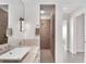 Bathroom featuring granite counters, sleek fixtures, textured wall shower, and minimalist design at 4765 Gulf Of Mexico Dr # B202, Longboat Key, FL 34228