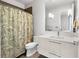 Well-lit bathroom featuring modern fixtures, a stylish shower curtain, and a sleek vanity at 4765 Gulf Of Mexico Dr # B202, Longboat Key, FL 34228