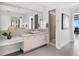 Elegant bathroom featuring double sink vanity, granite counters, large mirror, and contemporary design at 4765 Gulf Of Mexico Dr # B202, Longboat Key, FL 34228