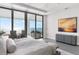 Bedroom featuring waterfront views from a private balcony, with modern decor and soothing color palette at 4765 Gulf Of Mexico Dr # B202, Longboat Key, FL 34228
