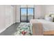 Comfortable bedroom features a large window, floral rug, and ample storage at 4765 Gulf Of Mexico Dr # B202, Longboat Key, FL 34228