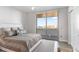 Light-filled bedroom with ceiling fan and balcony featuring views of the ocean and coastline at 4765 Gulf Of Mexico Dr # B202, Longboat Key, FL 34228