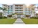 Stunning condo building with balconies, lush landscaping, and a beautiful entrance, perfect for luxurious coastal living at 4765 Gulf Of Mexico Dr # B202, Longboat Key, FL 34228