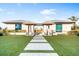Stunning modern home featuring manicured lawn and walkway leading to the impressive double entrance at 4765 Gulf Of Mexico Dr # B202, Longboat Key, FL 34228