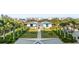 Picturesque grounds featuring lush tropical landscaping, community buildings and ample parking at 4765 Gulf Of Mexico Dr # B202, Longboat Key, FL 34228