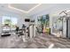 Bright home gym featuring ample workout equipment, large windows, and mirrored walls at 4765 Gulf Of Mexico Dr # B202, Longboat Key, FL 34228