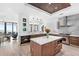 Modern kitchen with custom cabinets, stainless steel appliances, and a large island at 4765 Gulf Of Mexico Dr # B202, Longboat Key, FL 34228