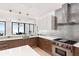 Open concept kitchen with bar seating, modern appliances, and stunning water views at 4765 Gulf Of Mexico Dr # B202, Longboat Key, FL 34228