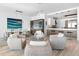 Bright living room featuring a modern kitchen, bar area, and comfortable seating with stylish decor and ample natural light at 4765 Gulf Of Mexico Dr # B202, Longboat Key, FL 34228