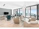 Open living room with floor to ceiling windows showcasing ocean views at 4765 Gulf Of Mexico Dr # B202, Longboat Key, FL 34228