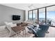 Bright living room with a view, showcasing modern furnishings and large glass doors that open to the outside at 4765 Gulf Of Mexico Dr # B202, Longboat Key, FL 34228