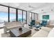 Bright living room with ocean views, showcasing modern furnishings and large glass doors that open to the outside at 4765 Gulf Of Mexico Dr # B202, Longboat Key, FL 34228