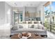 Inviting living room with comfortable seating, large windows, and a modern kitchen in the background at 4765 Gulf Of Mexico Dr # B202, Longboat Key, FL 34228