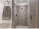 Modern shower stall with textured wall, sleek hardware, and a minimalist design at 4765 Gulf Of Mexico Dr # B202, Longboat Key, FL 34228