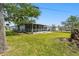 Expansive backyard with a screened-in patio, providing a private and enjoyable outdoor living space at 4803 Brae Burn Ave, Sarasota, FL 34234