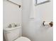 Bathroom with white walls, toilet, and a towel rack near the window at 4803 Brae Burn Ave, Sarasota, FL 34234