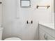 Bright bathroom featuring white walls, toilet, sink, and a small window at 4803 Brae Burn Ave, Sarasota, FL 34234