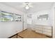 Bedroom with hardwood floors, ceiling fan and dresser with overhead mirror at 4803 Brae Burn Ave, Sarasota, FL 34234