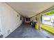 Spacious covered carport with ample storage, connecting to a backyard with a screened-in patio at 4803 Brae Burn Ave, Sarasota, FL 34234