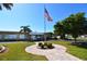 Landscaped clubhouse with an American flag at 4803 Brae Burn Ave, Sarasota, FL 34234