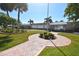 Community clubhouse and manicured lawn with lush landscaping at 4803 Brae Burn Ave, Sarasota, FL 34234