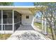 Exterior shot of a home with a covered patio and access to the backyard at 4803 Brae Burn Ave, Sarasota, FL 34234