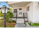 Welcoming front porch with a decorative lamp, lush landscaping, and a clean entryway, enhancing curb appeal at 4803 Brae Burn Ave, Sarasota, FL 34234