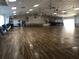 Spacious community hall with wood floors, stage, and ample seating for gatherings and events at 4803 Brae Burn Ave, Sarasota, FL 34234