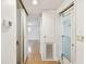 Hallway featuring hardwood floors, white walls, and an entry way at 4803 Brae Burn Ave, Sarasota, FL 34234