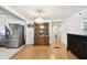 Kitchen and dining area with wood flooring, refrigerator and decorative wooden hutch at 4803 Brae Burn Ave, Sarasota, FL 34234