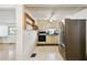 Galley kitchen features stainless steel refrigerator and range with ample cabinet space at 4803 Brae Burn Ave, Sarasota, FL 34234