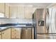 Galley kitchen features stainless steel refrigerator and matching dishwasher at 4803 Brae Burn Ave, Sarasota, FL 34234