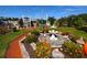 Manicured landscaping featuring a fountain and flower garden at 4803 Brae Burn Ave, Sarasota, FL 34234