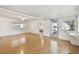 Living room with hardwood floors, white walls, a ceiling fan, and natural light at 4803 Brae Burn Ave, Sarasota, FL 34234